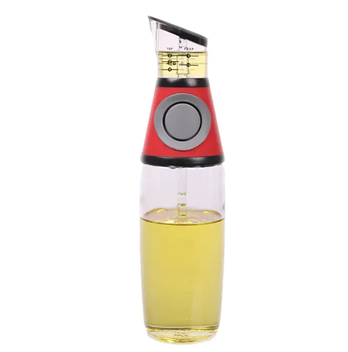 Oil and vinegar dispenser with red top and clear body on a white background
