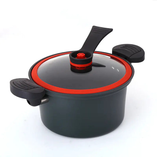 Black pressure cooker with red interior on a white background